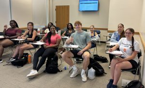 Students sitting at desks in classroom.