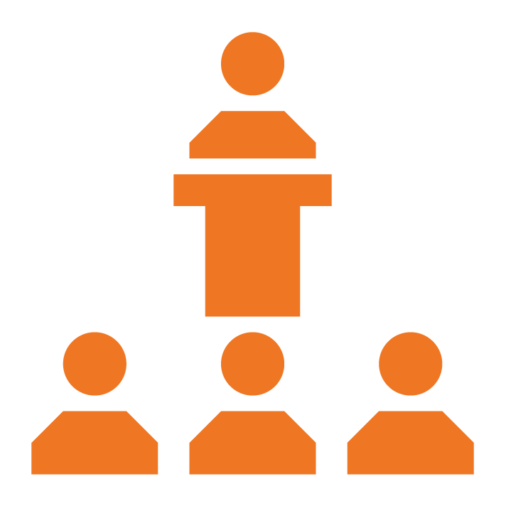 Person at podium in front of three other people icon
